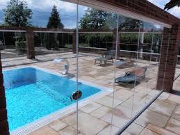 Frameless Glass Doors Installed Around An Outdoor Pool Keeping Off The Chill Winds Frameless Glass Doors Glass Door Glass Curtain
