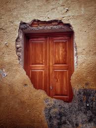 Premium Photo | Wooden door seen from broken wall