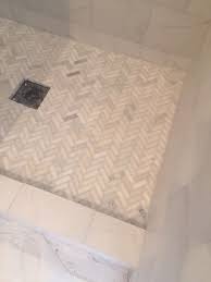 Ceramic tile, porcelain tile, natural stone tile, glass tile From Hellolovely Com An In Progress Shower Tiled In A Carrara Marble Herringbone Marble Herringbone Shower Floor Master Shower