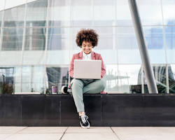 Image of person working on laptop outdoors