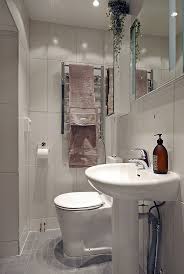 A tiny bathroom still comes with walls—so use height to your advantage. Picture Of Swedish Apartment Design With Open Floor Plan
