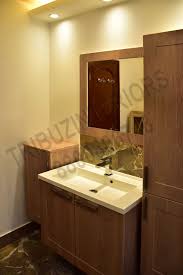 Get contact details and address | id: Bathroom With Wooden Cabinets And Wash Basin By Tribuz Interiors Pvt Ltd