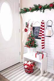 Indoor decorations often begin with an evergreen tree that is decorated with lights, ornaments, and a star. 25 Warm And Welcoming Christmas Decorated Entryway Ideas