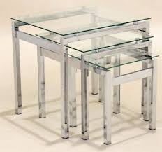 The thick tabletop gives it heft, while a minimalist chrome frame offsets it. Nest Of Three Glass Coffee Tables Atlantic Online Reality