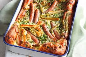 Toad in the hole or sausage toad is a traditional english dish consisting of sausages in yorkshire pudding batter, usually served with onion gravy and vegetables. Toad In The Hole Recipe Family Recipes Tesco Real Food