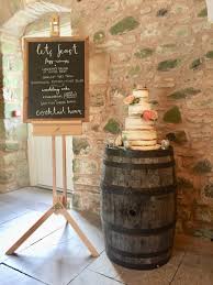 Cake On Barrel With Wedding Schedule On Blackboard And Easel Wedderburn Barns Barnwedding Rusticwedd Wedding Cake Roses Wedding Schedule Rustic Wedding