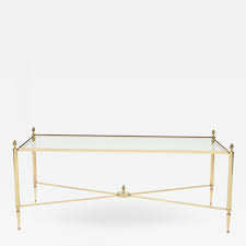 Each frame has slim cross bars for a stur. Maison Bagues French Maison Bagues Brass Glass Coffee Table 1950s