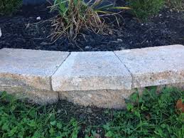 A retaining wall of light stacked stone that is uniform in color and size. How To Cut Stone Caps For A Curved Retaining Wall With Photos Pretty Purple Door