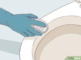 Few years back we couldn't get metal stains out of a tile i think something along the same lines something was drug across tile, so we cut the grout lines and busted em out, we tried a bunch of stuff, finally used on high gloss porcelain, we have used a windshield repair kit. 3 Ways To Clean Metal Marks Off A Porcelain Toilet Wikihow