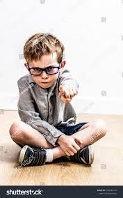 Scary Sulking Boy Seated On Floor Pointing His Teacher Like Finger Accusing Or Denouncing Education Or Authority Ex Stock Photos Unique House Design Frowning