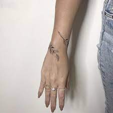 A beautiful butterfly tattoo on the ladies wrist Bracelet Tattoo Ideas Popsugar Beauty