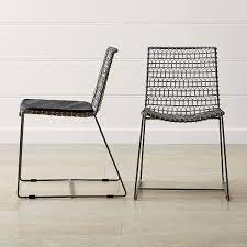 A wooden seat and back can add warmth to the look of an elegant contemporary chair that is made of metal. Tig Metal Dining Chair Crate And Barrel Metal Dining Chairs Kitchen Chair Cushions Modern Dining Chairs