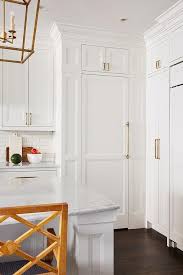 Beautifully White And Gold Kitchen Features A Hidden White Pantry Door Adorned With A Long Brass Handle And Fixe Kitchen Pantry Doors Pantry Door Hidden Pantry