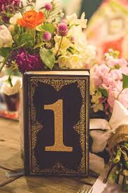 Table Number Ideas To Suit Every Wedding Theme Wedding Numbers Vintage Wedding Table Book Themed Wedding