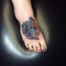 Anchor tattoo on the foot with a black ink design. 170 Awesome Anchor Tattoos Ultimate Guide April 2021