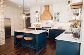 Accent colors include a deep brown range hood, black kitchen island, and deep grey marble countertops. 24 Blue Kitchen Cabinet Ideas To Breathe Life Into Your Kitchen