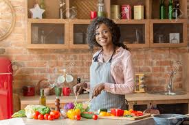 Traditional and modern recipes from africa, america, and the caribbean. Joyful African American Lady Mixing Veggies In Bowl In Kitchen Stock Photo Picture And Royalty Free Image Image 133676571