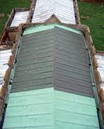 Classic green patina applied to copper diamond shingles. Copper Sheet Roofing