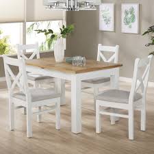 Crafted from solid wood with turned legs, the table, chairs and bench pair warm stained oak and painted white finishes for a versatile look that works well in a variety of kitchen or dining room. White Extendable Dining Table In Solid Wood With An Oak Top Aylesbury Furniture123