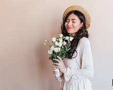 person smiling and holding a beautiful flower arrangement they createdの画像