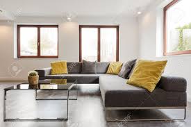 From an end table to a coffee table, to a stool, to a magazine rack, to a little a laptop desk. Large Corner Sofa And Glass Coffee Table In A Very Modern And Light House Interior Stock Photo Picture And Royalty Free Image Image 60695112