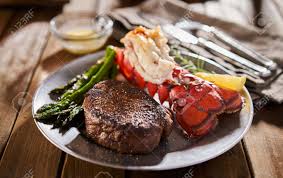 Lobster is more of a novelty food, a good excuse to put on a bib and eat drawn butter. Tasty Surf Turf Steak And Lobster Meal With Asparagus On Dinner Stock Photo Picture And Royalty Free Image Image 52816020