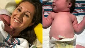 There we were...my wife and I in a tiny stall in the bathroom, and I could  see the top of our little girl's head crowning as Maggie was straddling the  toilet." Full