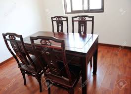 You can still get a pure wood finish with a lot of texture in your home without using paint or useless accessories — just change your usual laminate table for one of those raw plain wood planks. Chinese Dining Room With Dark Wood Table Four Chairs And Window Stock Photo Picture And Royalty Free Image Image 13866869