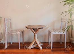 The furniture of america jared 5 piece rustic dining table set comes with two benches and two chairs, allowing you to accommodate six people. Retro Wooden Table Set With Two Chairs Over Empty White Wall For Copy Space Stock Photo Picture And Royalty Free Image Image 128323521