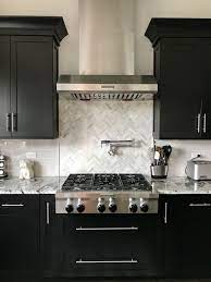 Stainless steel prices fluctuate, so buy when pricing is low. Espresso Cabinets With Light Grey Subway Backsplash Herringbone Backsplash With Brown Kitchen Cabinets Espresso Kitchen Cabinets Dark Brown Kitchen Cabinets