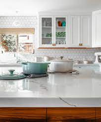 The orange countertops were swapped for custom concrete countertops. Porcelain Or Ceramic Tile Best Kitchen Backsplash Materials Explained