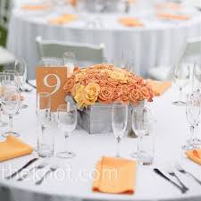 For The Outdoor Celebration Orange Centerpieces Of Roses Packed Into Square Silver Container Rose Centerpieces Silver Wedding Centerpieces Orange Centerpieces