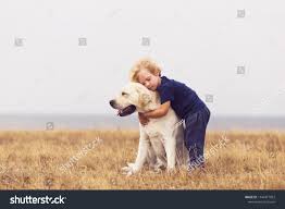 adorable boy hugging her labrador retriever happy kid with big white dog outdoors child and his d black labrador retriever labrador retriever dog best friend