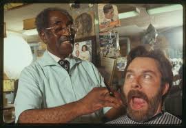 Louis McDowell pretends to give fieldworker David Taylor a shave and a  haircut.