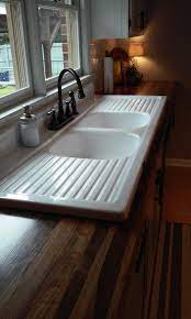 I know of several sources for a reproductions of apron style farmhouse drainboard sinks. Finished Our Wooden Countertops And Installed Our 65 Yr Old Farmhouse Drainboard Sink More Pictures O Rustic Kitchen Sinks Comfortable Kitchen Rustic Kitchen