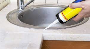 Have a towel or a bucket ready to collect any leakage. Plumber Putting A Silicone Sealant To Installing A Kitchen Sink Stock Photo Picture And Royalty Free Image Image 12303129