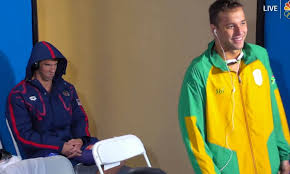 The champion swimmer, above, has a colourful tattoo of the olympic rings on his right hipbone ryan lochte: Somebody Already Got An Angry Michael Phelps Death Stare Tattoo For The Win