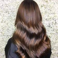 Dark brown hair and caramel chocolate hair color in highlights create a harmonious color scheme that equally fits straight, wavy, and curly hair. All About The Chocolate Brown Hair Trend Wella Professionals
