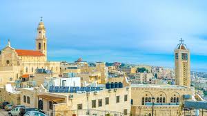 United nations workers empty trash cans at a garbage dump behind the painted separation barrier in bethlehem in the west bank (palestinian territories). A New Side To The Holy City Of Bethlehem Bbc Travel