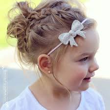 Messy braided updo with two slide-up three strand braids