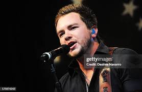 Guitarist James Young, drummer Chris Thompson, singer Mike Eli and... News  Photo