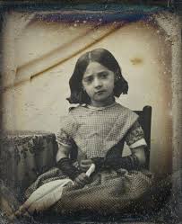 Portrait of a child with a knife, circa 1880s.