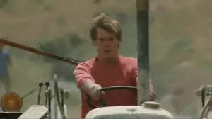 Cartoon singing happily while holding a guitar. Chicken With Tractors Kevin Bacon Lori Singer Footloose Animated Gif