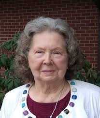 Sarah Douglas is reading her May 16, 1977 issue of Newsweek magazine