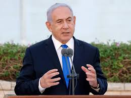 A coalition of eight parties came a demonstrator wearing a mask showing benjamin netanyahu's face holds up his handcuffed hands during a rally celebrating the new coalition. End Of Benjamin Netanyahu Era Could Be In The Cards In Israeli Political Drama Times Of India