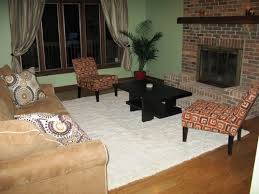 This is a contemporary living room with a stone fireplace and a simple mantle. How To Arrange Furniture Around Fireplace And Corner Tv