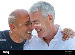 Senior gay male couple, laughing and affectionate, carefree and