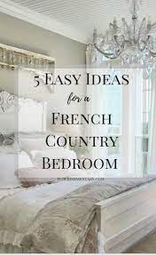 Modern french bedroom features rustic wood beams over a white cane bed dressed in plush white bedding and an union jack pillow flanked by french nightstands next to a wall of factory windows. 5 Easy French Country Bedroom Ideas Flourishmentary
