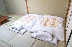 A shikibuton is a floor mattress. Futon A Japanese Quilted Mattress Rolled Out On The Floor Tatami Stock Photo Picture And Royalty Free Image Image 123824609