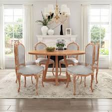 A shabby chic meets rustic white dining room with elegant vintage furniture, an old chandelier and potted plants and blooms. Shabby Chic Teak Wood Round Dining Table Chair Set